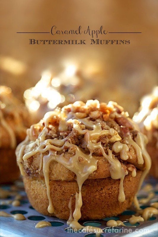 Photo of a baking grate filled with Caramel Apple Buttermilk Muffins with the frosting melting onto the grate. A text graphic title is at the top of the photo.