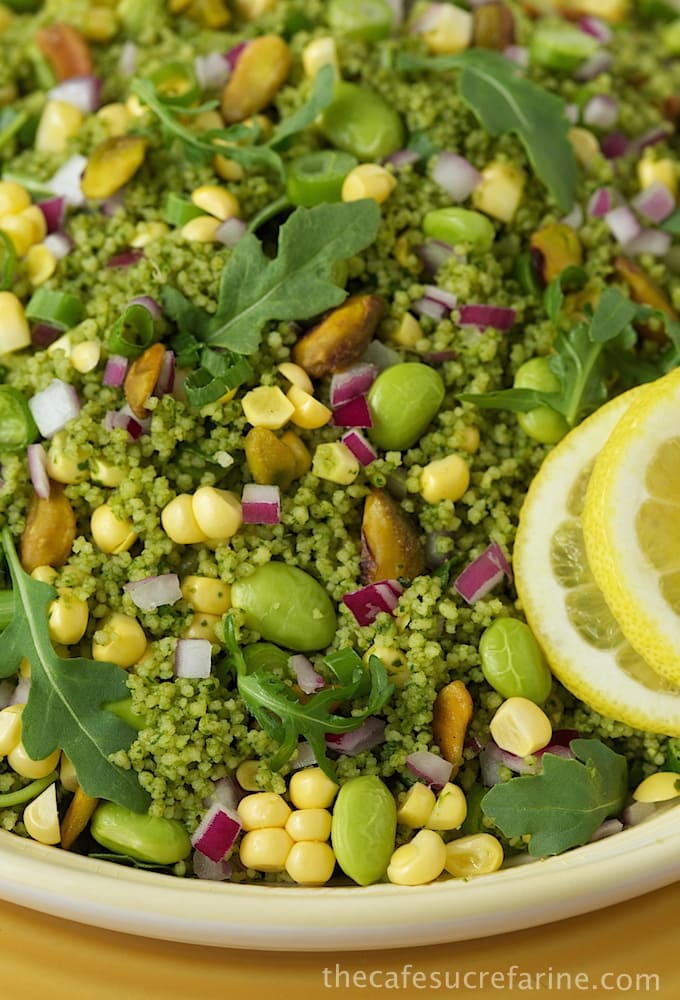 Overhead photo of a plate of Green on Green Couscous Salad garnished with lemon slices.