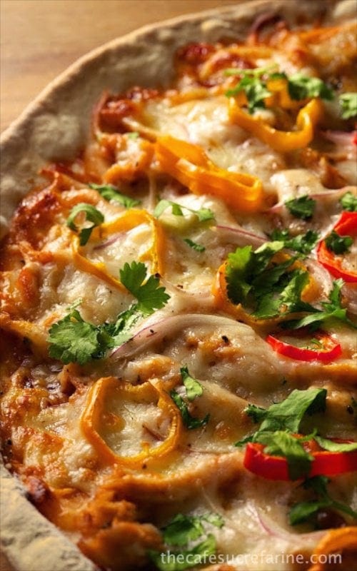 Thin Crust Barbecue Chicken Pizza - amazingly delicious and easy to make! The barbecue chicken shares the spotlight with onions, peppers and cilantro. A perfect pizza for those, "What's quick for dinner?" nights.