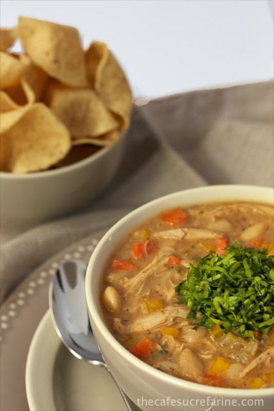 White Bean Chicken Chili - a hearty, delicious chili with Southwestern flair. Onions, carrots, celery and yellow bell peppers and a touch of smokiness, thanks to a little sautéed bacon make this chili a real winner!
