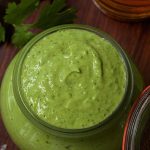 Vertical overhead picture of avocado crema in a glass jar