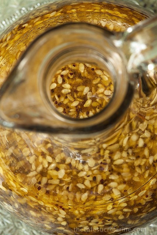 A closeup overhead photo of Asian Honey-Sesame Salad Dressing in a cruet.
