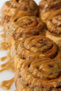 Easy Cinnamon Rolls with Caramel Icing - Fabulous cinnamon and walnut swirled sweet rolls with a to-die-for silk caramel drizzle. Start to finish in less than 2 hours!