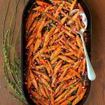 Overhead picture of Honey Maple Roasted Carrots in a cast iron baking dish