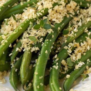 Green Bean casserole, it's a given, right? How about being a bit of a renegade this year? How about ... fresh, tender green beans tossed in a light, lemony butter sauce and topped with crisp, lemon-herb panko crumbs? I know, I know, Green Bean casserole is a family institution and even better more than that, it can be made ahead and just popped in the oven at the towards the end of the holiday meal prep. Guess what? Although these delicious green beans may not be a family institution, they have the potential to become quite revered and even better than that, everything can be done ahead and then warmed a few minutes before serving. The beans are quickly blanched, then drained and plunged into cold, icy water to stop the cooking process. The lemony, buttery panko crumbs also take just a few minutes to prepared and can be stored in a zippered bag or small glass jar till it’s time for dinner. All that’s needed later is a hot pan to melt the butter and toss the brightly hued beans. Transfer them to a serving platter, scatter with the flavorful crumbs and dazzle your guests. That’s it! Start a new tradition. They’ll be begging for this one again and again!