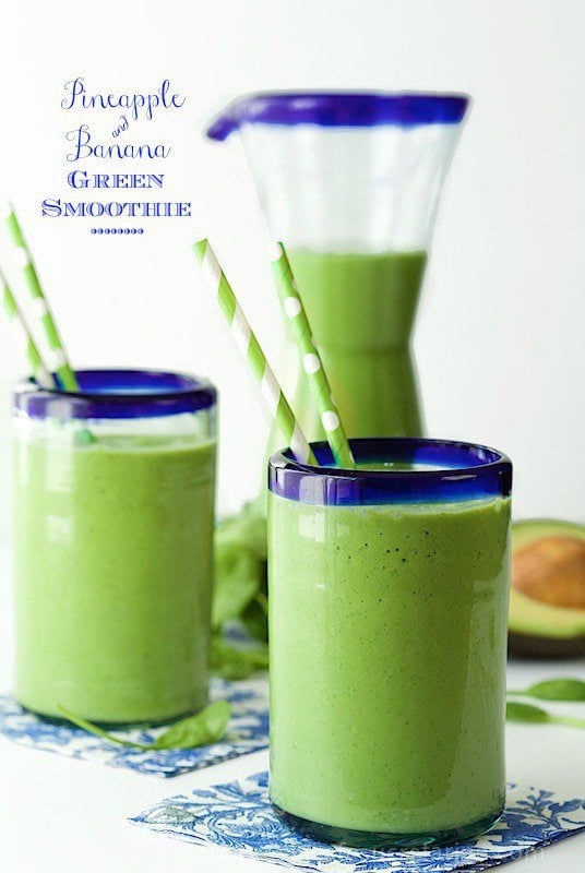 Photo of blue-trimmed glasses of Pineapple and Banana Green Smoothie with a pitcher and graphic description in the background.