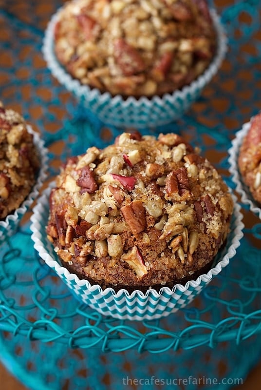 Vertical closeup photo of Morning Glory Muffins with Candied Pecan Topping in turquoise and white baking cups.