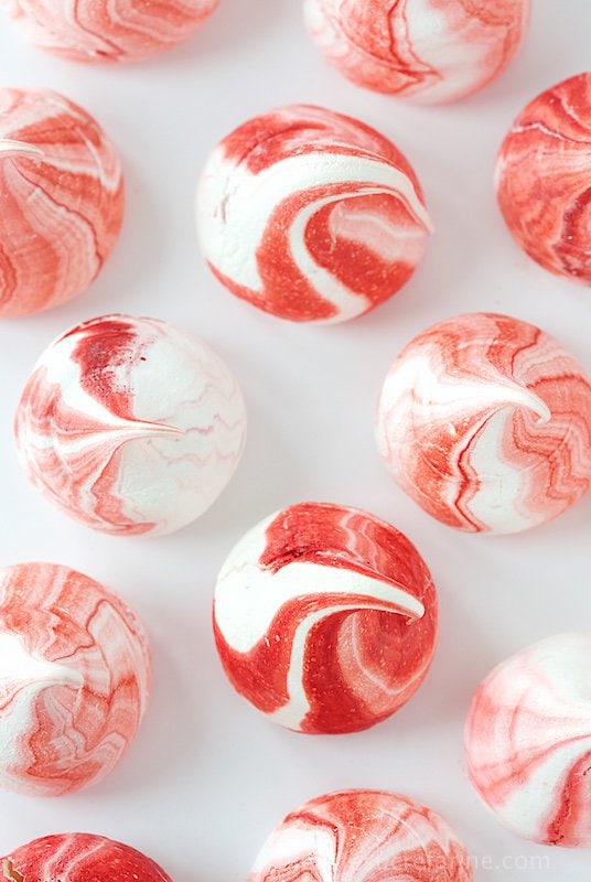 Red Velvet Meringue Kisses - melt in your mouth meringue kisses with a delightful touch! The stripes have the delicious essence of Red Velvet!