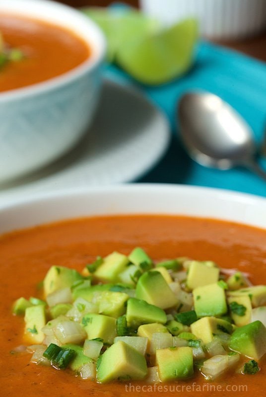 Southwestern Tomato and Roasted Red Pepper Soup - hearty, healthy and super flavorful, this soup is loaded with lots of great veggies and a burst of south-of-the-border flavor. The avocado salsa takes it right over the top!