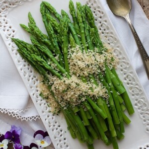 Overhead picture of Asparagus with Lemon Parsley Panko on a white platter