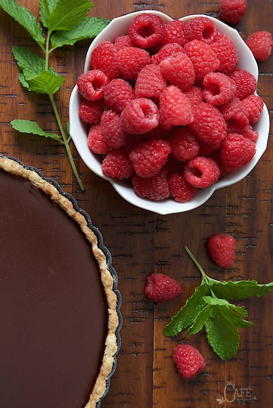 Close up picture of French Chocolate Tart with Brown Butter Crust and raspberries