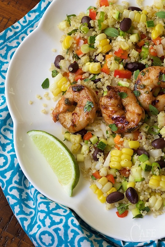 Close up picture Chopped Mexican Quinoa Salad with Chili Lime Shrimp on a white plate