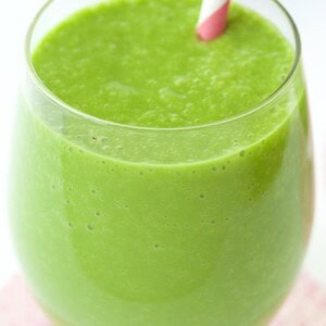 Vertical closeup photo of a Peach and Fresh Pineapple Green Smoothie