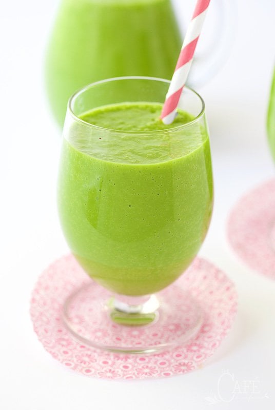 Peach and Fresh Vertical picture of Pineapple Green Smoothie in a glass with a straw