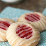 Vertical picture of Peach Raspberry Thumbprint Cookies on a turquoise napkin