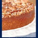 Vertical closeup photo of a Ridiculously Easy Farmhouse Buttermilk Cake on a white pedestal cake stand with a blue outline around the photo and a word graphic at the bottom.