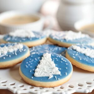 Easy Decorated Christmas Cookies (A Snowy Night in the Mountains Cookies) on a white lattice plate.