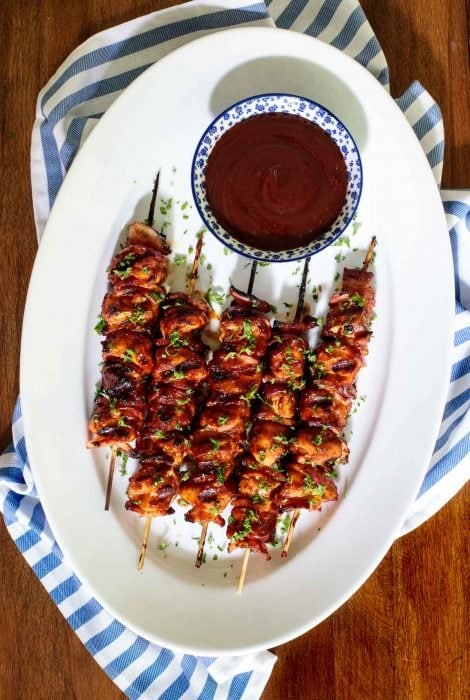 Vertical picture of Barbecued Chicken Skewers on a white platter
