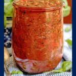 Vertical photo of a tall glass Weck jar filled with Quick and Easy Marinara Sauce.