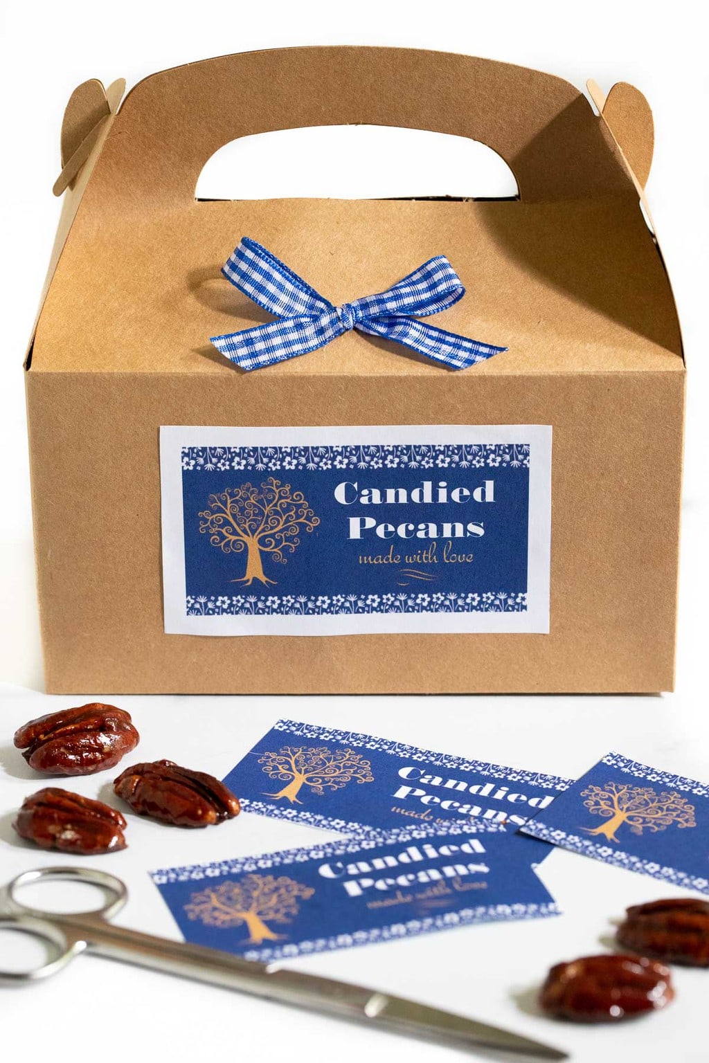 Vertical photo of a gift box of Easy Candied Pecans with a custom label attached.