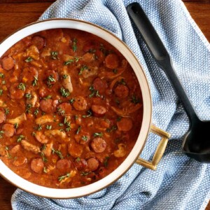 Horizontal overhead photo of a pot of Make-Ahead Chicken Andouille Gumbo on a wood table.