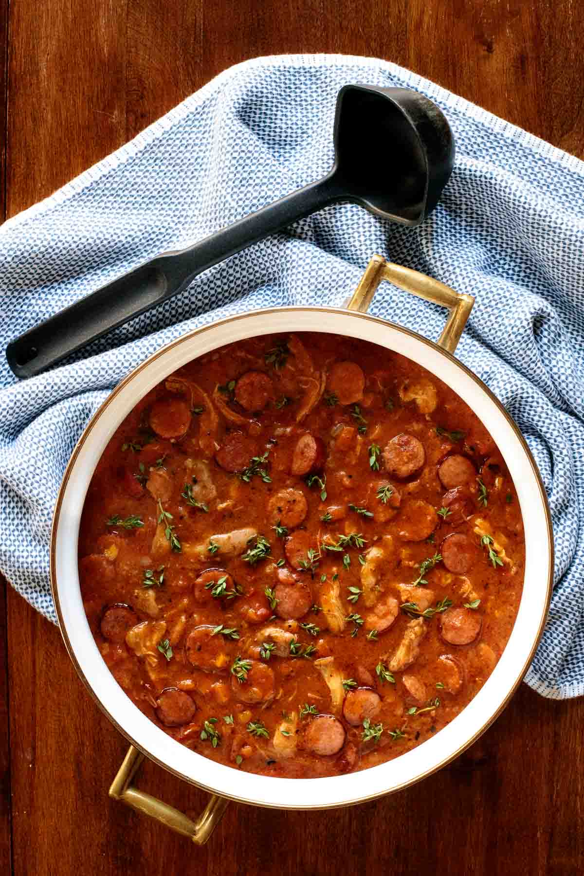 Vertical overhead photo of a pot of Make-Ahead Chicken Andouille Gumbo on a wood table.