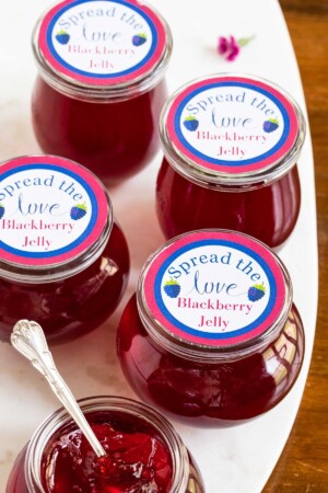 Jars of Blackberry Jelly with custom blue, red and green labels.