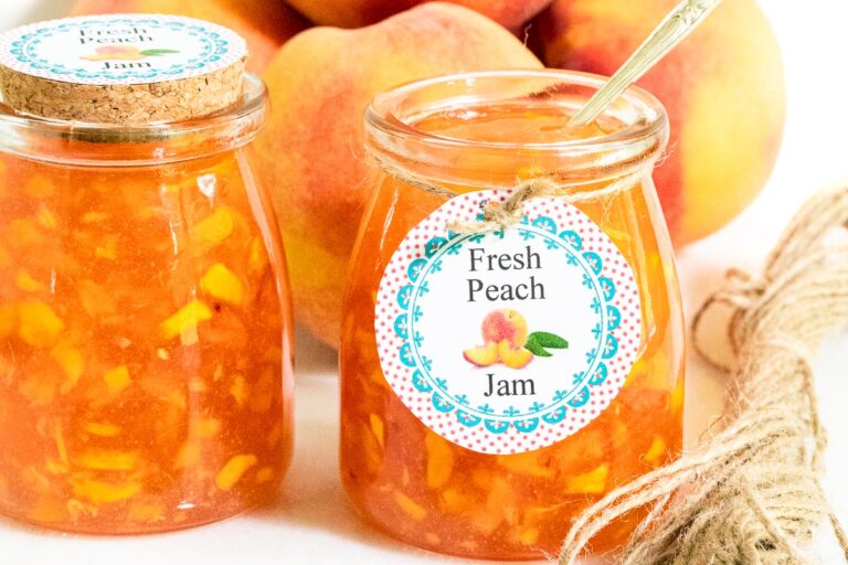 close up of a batch of Peach Freezer Jam with custom labels for gift giving.