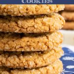Vertical extreme closeup photo of a stack of Crinkly Crackly Peanut Butter Cookies on navy blue patterned napkins.
