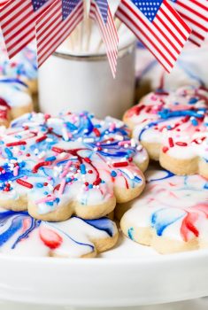 Horizontal closeup photo of a batch of Red, White, and Blue Glazed Shortbread Cookies