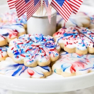 Horizontal closeup photo of a batch of Red, White, and Blue Glazed Shortbread Cookies
