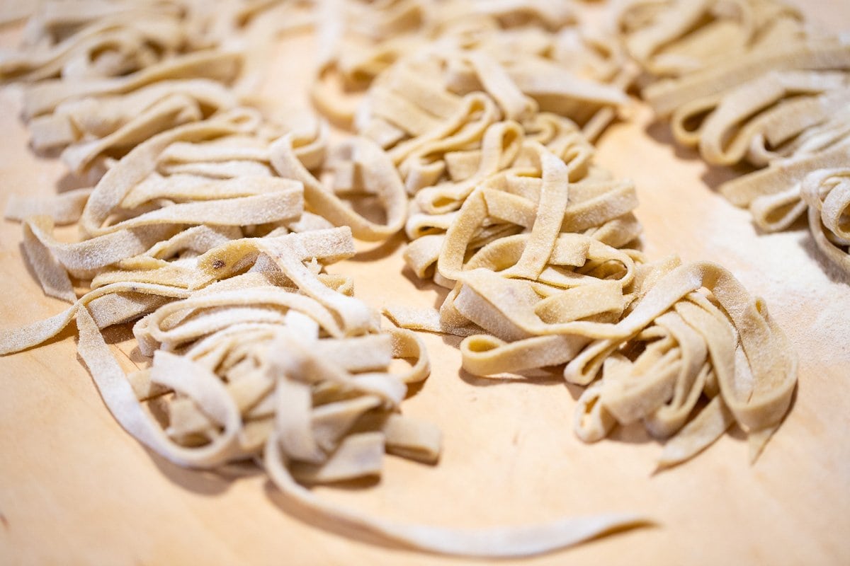 Horizontal closeup photo of homemade porcini pasta.