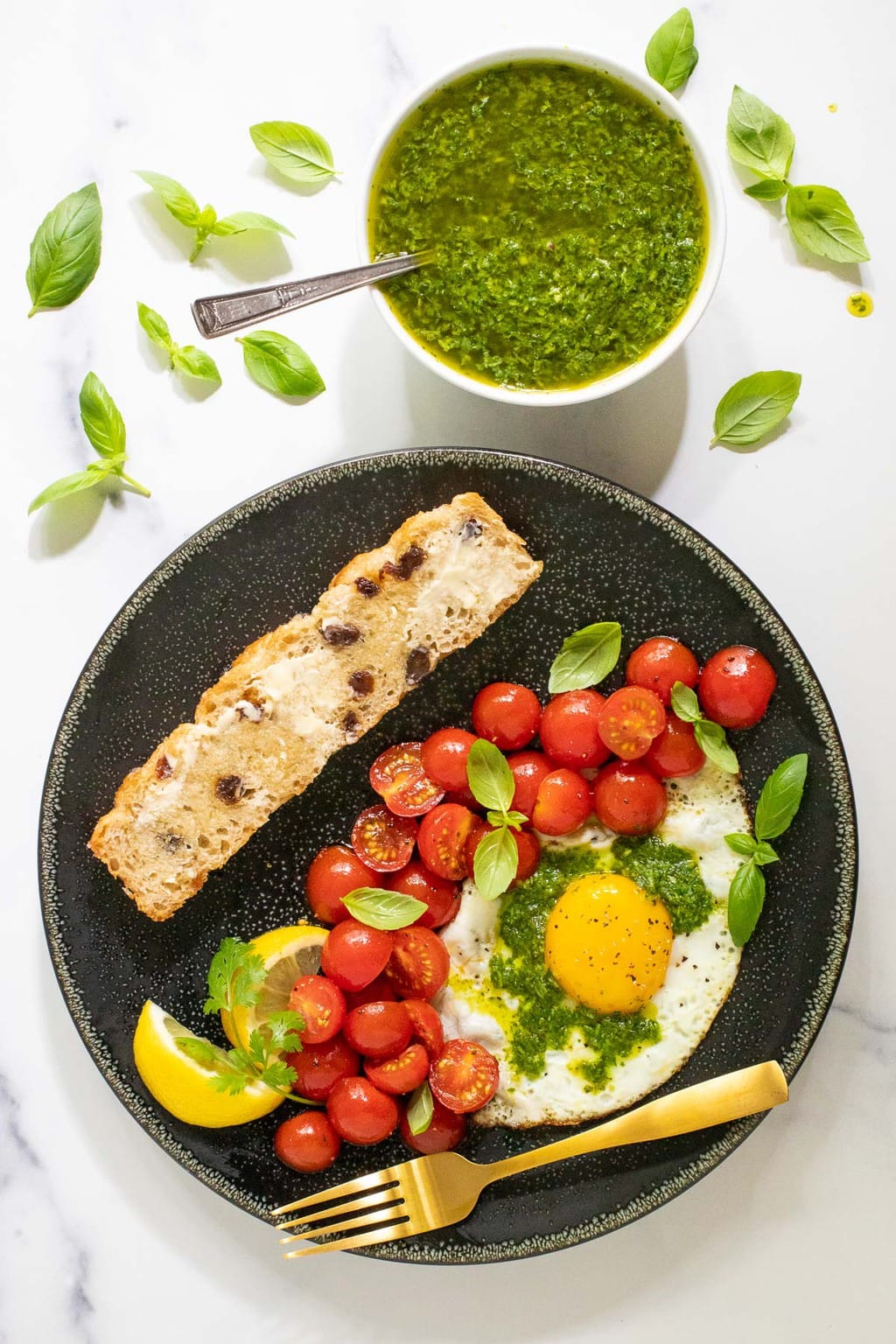 Vertical overhead picture of eggs and tomatoes and bread with 15 Minute Chimichurri Sauce.