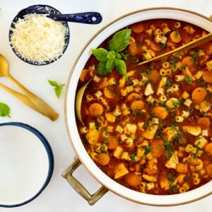 Italian chicken vegetable soup in a white dutch oven.