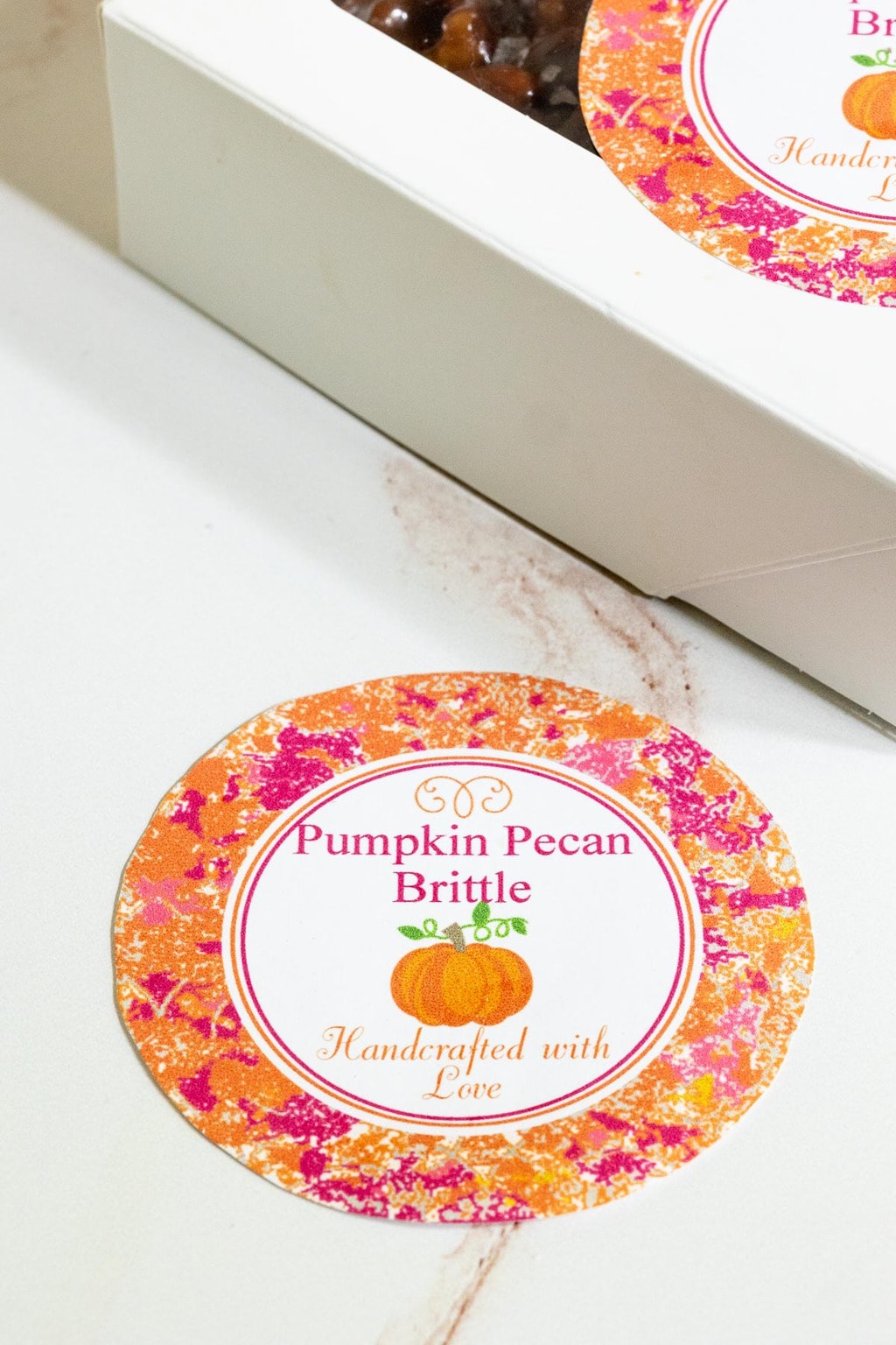 Vertical closeup photo of a Sea Salted Pumpkin Pecan Brittle custom gift label.