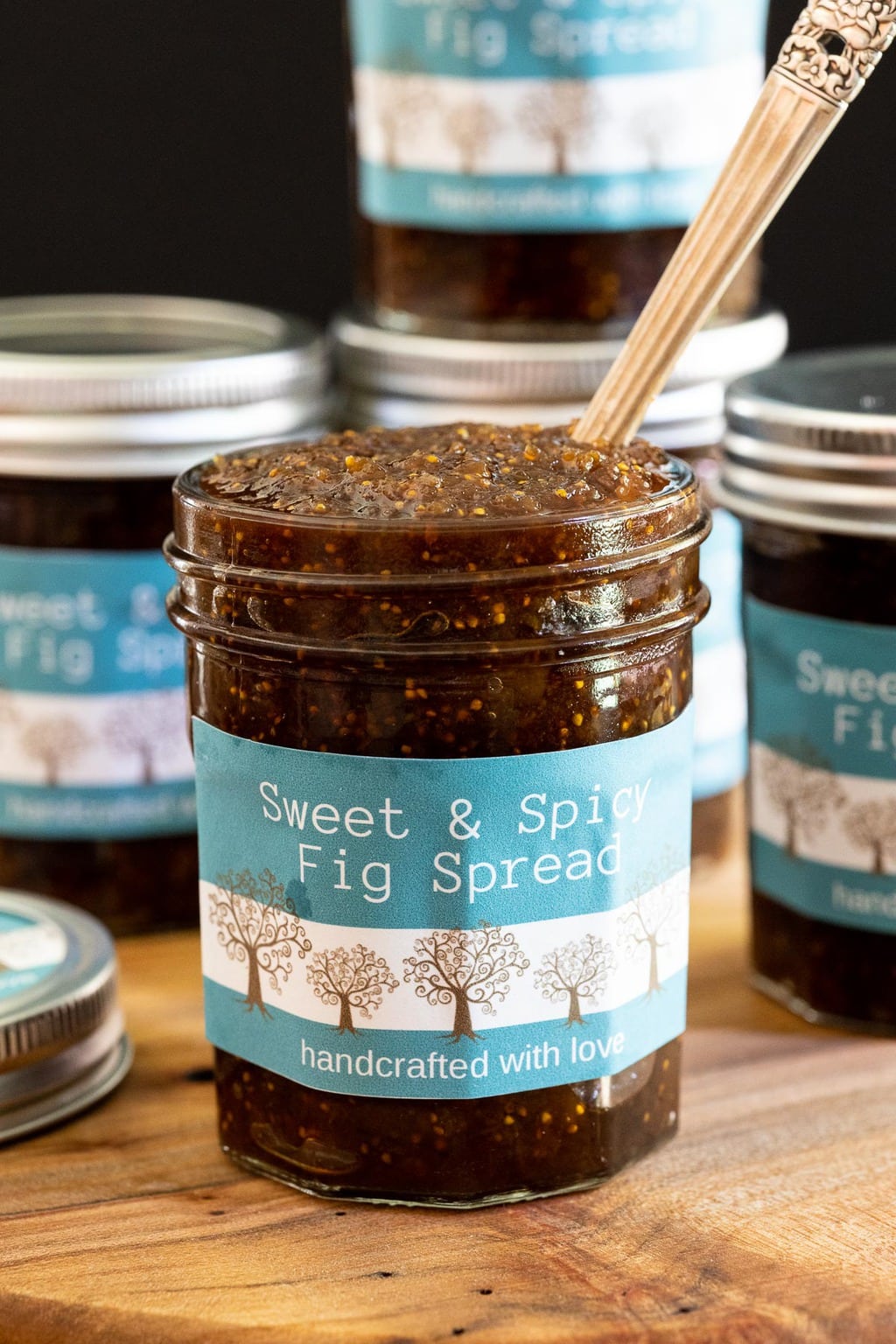 Vertical picture of Sweet and Spicy Fig Spread in a glass jar with turquoise label