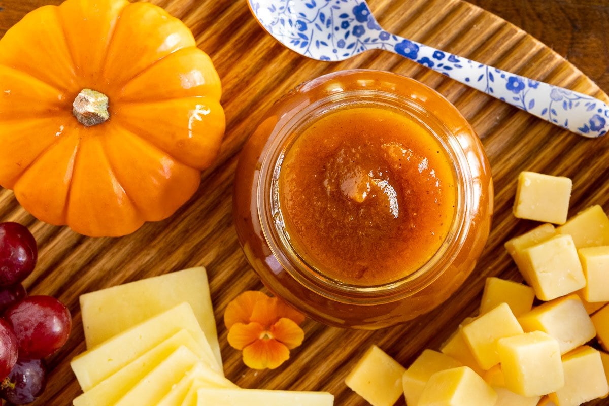 Horizontal overhead closeup photo of a fall appetizer tray featuring Pumpkin Jam (Confiture De Citrouille) in a glass Weck jars.
