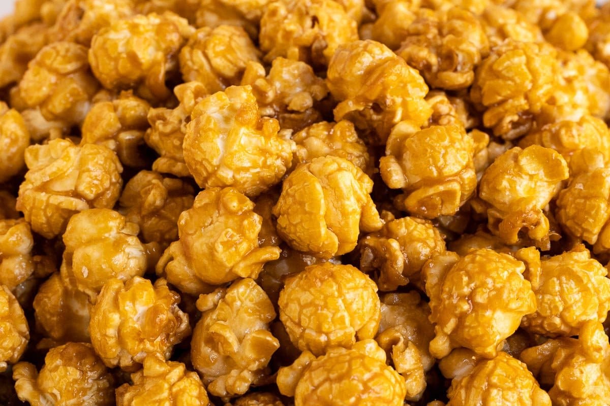 Horizontal extreme closeup photo of a batch of Ridiculously Easy Sea Salted Microwave Caramel Corn .