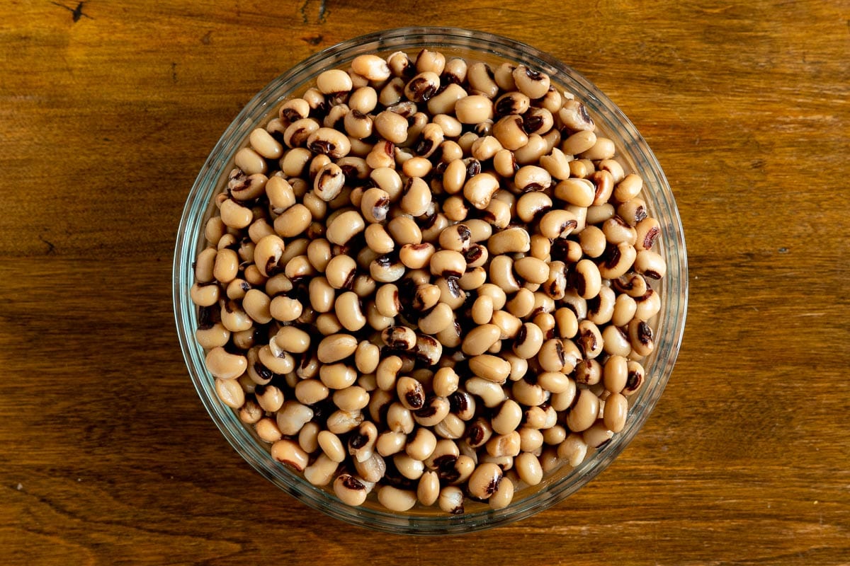 Horizontal overhead photo of a glass bowl filled with black-eyed peas ready for making Healthy Hoppin' John.