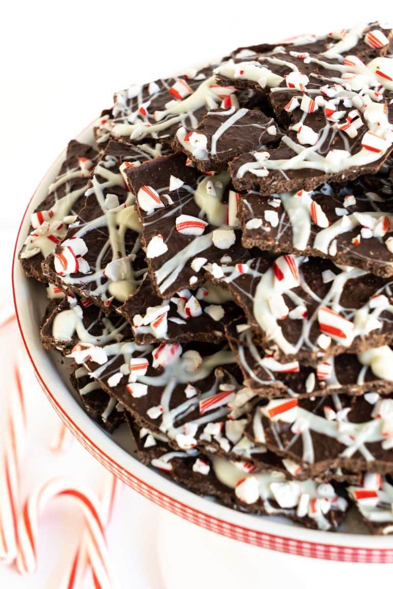 Vertical close up picture of Peppermint Bark Brittle on a white cake stand