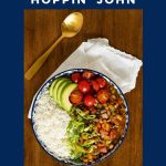 Vertical overhead photo of a serving dish of Healthy Hoppin' John, white rice, sliced avocado, tomatoes and onions on a wood table.