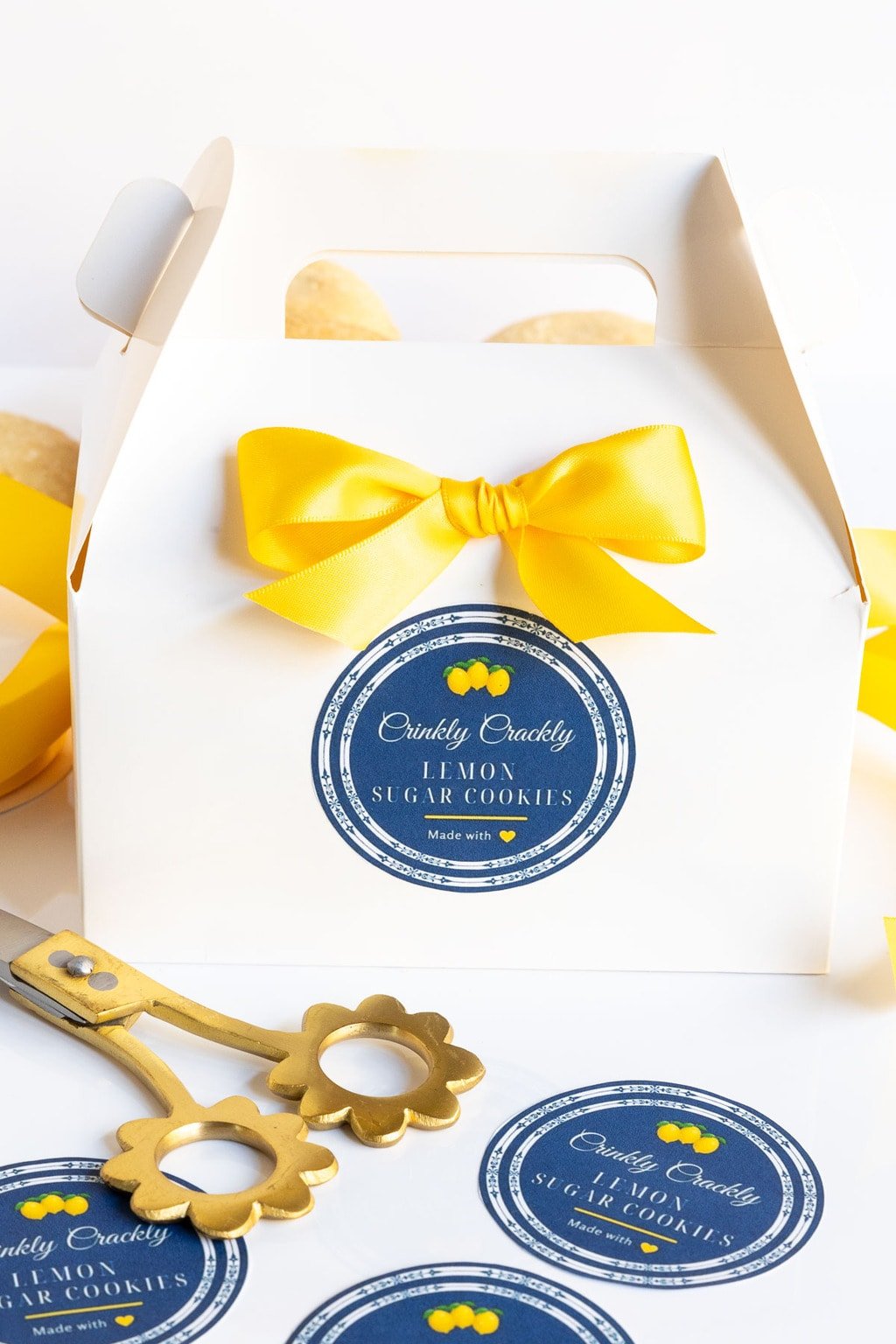 Vertical photo of custom Crinkly Crackly Lemon Sugar Cookie labels and a decorative box for gift giving