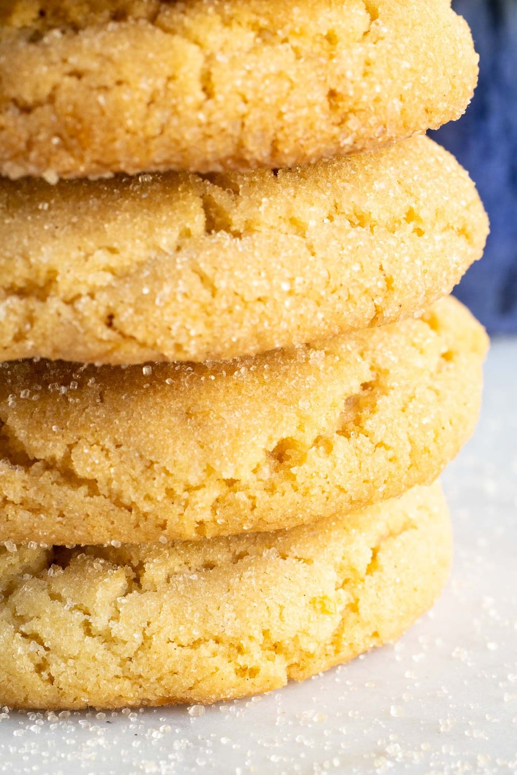 Vertical extreme closeup of the edge of a stack of Lemon Sugar Cookies.