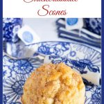 Vertical closeup photo of a Ridiculously Easy Snickerdoodle Scone on a blue and white patterned serving plate with a word graphic title at the top of the photo.