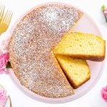 Horizontal overhead photo of a Ridiculously Easy French Butter Cake on a pink pedestal cake stand.