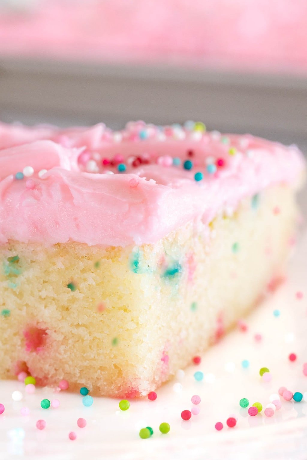 Vertical extreme closeup of a slice of Ridiculously Easy Funfetti Sheet Cake.