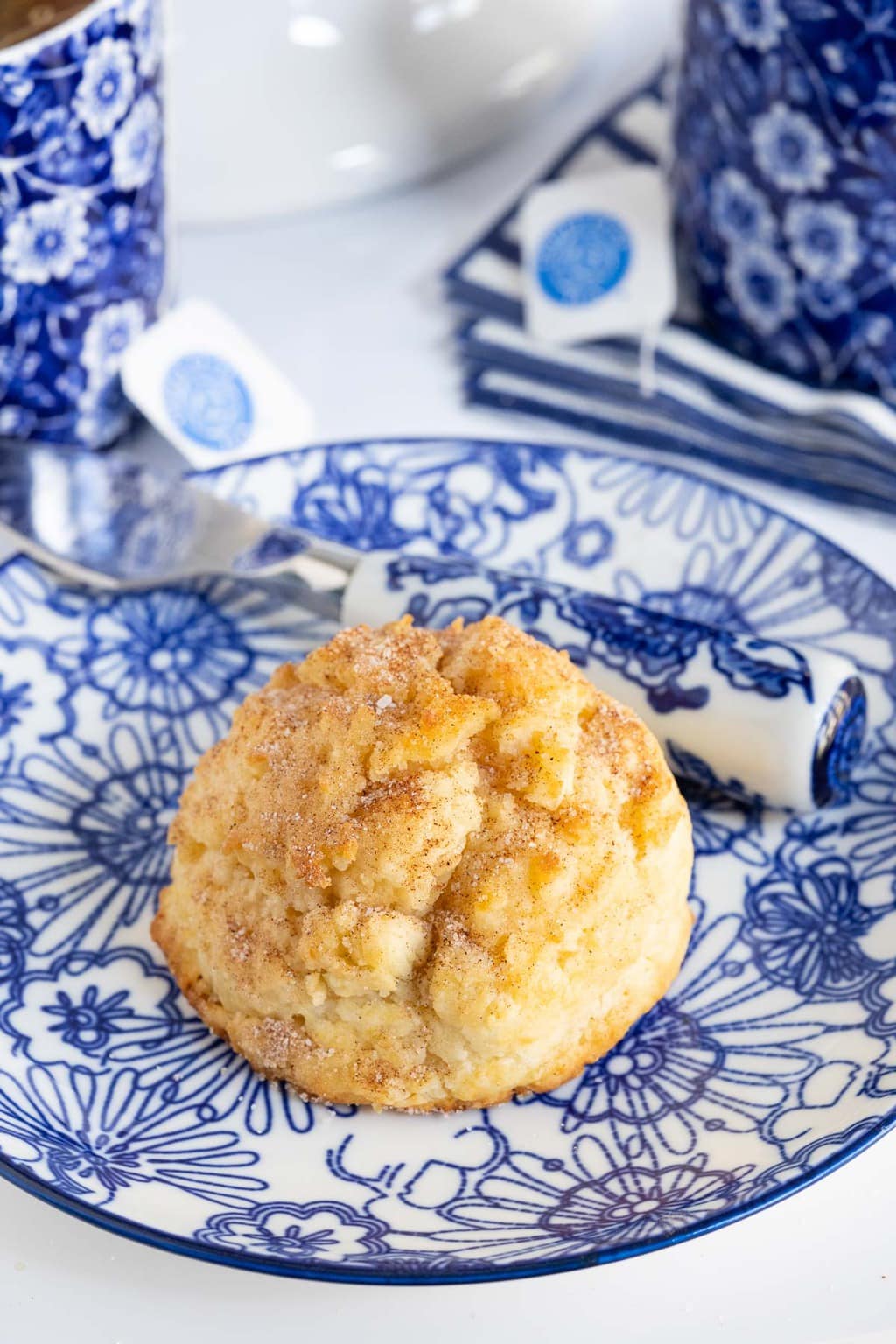 Vertical photo of a Ridiculously Easy Snickerdoodle Scone on a blue and white patterned serving plate.