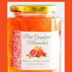 Vertical closeup photo of a jar of Pink Grapefruit Marmalade with a custom gift label for the jar.