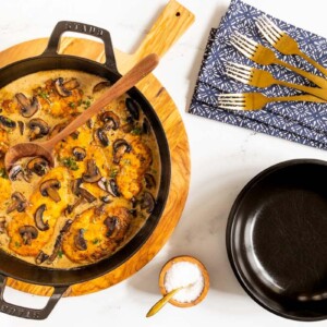 Horizontal overhead photo of a black cast iron pan filled with Weeknight or Dinner Party Chicken Marsala.