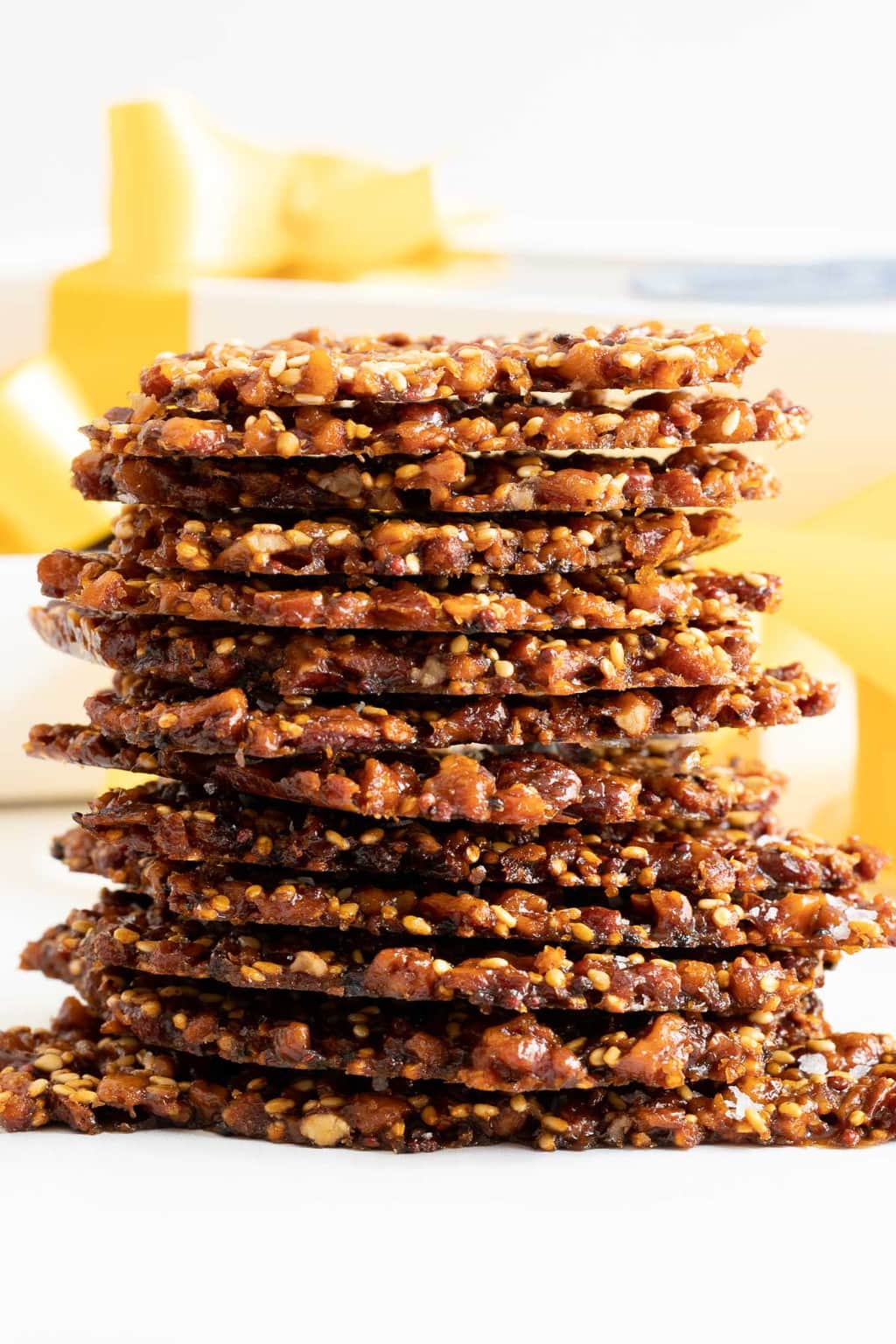 Vertical closeup photo of a stack of Sea-Salted Quinoa Pecan Brittle.